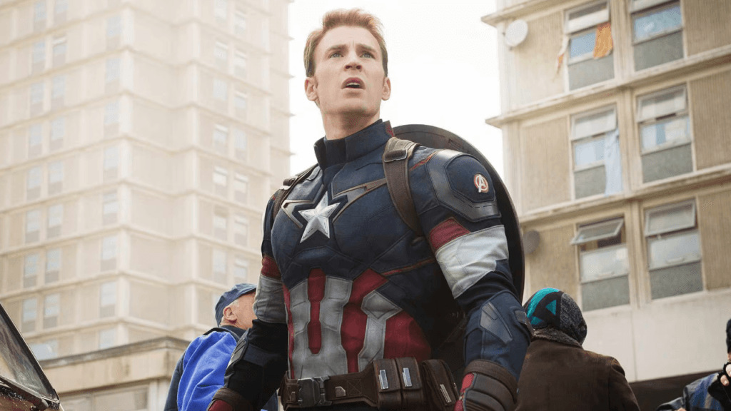 Chris Evans as Steve Rogers wearing the Captain America suit, standing alert in an urban setting during Avengers: Doomsday teaser scene.