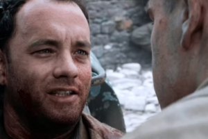 Why Victory Sometimes Feels Sad in Cinema 5 A tight, emotional close-up of a bloodied and battered Tom Hanks as Captain Miller in Saving Private Ryan, whispering his final words to another soldier. His weary, pained eyes reflect the devastating human cost and bittersweet nature of achieving a military victory.