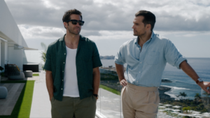 Jake Gyllenhaal and Henry Cavill. in a still of In the Grey Review Roundup: Critics are split over Guy Ritchie’s slick but overloaded action caper.