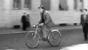 Why Ordinary Characters Often Make Extraordinary Stories 1 A still from Bicycle Thieves showing an ordinary working-class man riding a bicycle, symbolizing everyday life and the power of ordinary people in cinema.