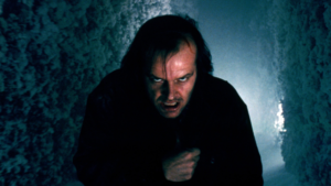 Why Horror Has Always Found Its Natural Home in Theatres 1 Jack Torrance in The Shining (1980), Stanley Kubrick's psychological horror classic celebrated for its immersive theatrical atmosphere.