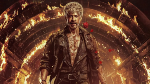 Shah Rukh Khan in the new poster for King, featuring a rose between his teeth and a gun in his hand.